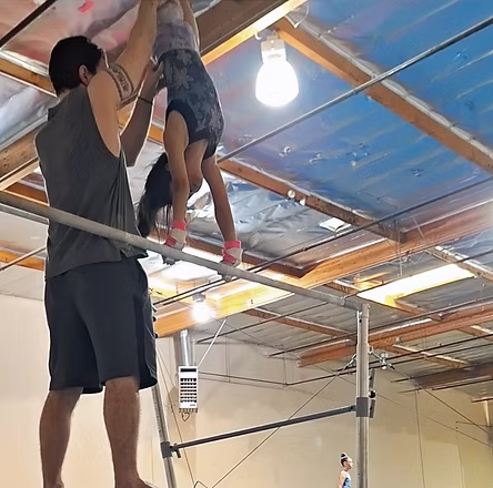 Competitive gymnast training with a Sandstorm coach
